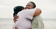 © peopleimages.com - Happy, mother and black woman with hug on beach for travel, holiday and family trip. Outdoor, African parent and embrace with mature mom, tropical vacation and affection for love or bonding together