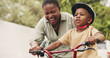 © AzeemudDeen/peopleimages.com - Support, teaching and boy on bicycle with mom on street of neighborhood for child development. African woman, smile or black kid with trust, help or single mother to learn how to ride bike outside