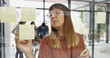 © peopleimages.com - Office, businesswoman and writing on glass wall for sticky note, strategy and idea for creative agency. Boardroom, female person and writer with planning for information, brainstorming and startup