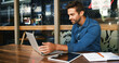 © peopleimages.com - Laptop, man and freelancer reading in coffee shop for article, update review or journalist check email. Computer, remote work and happy person in cafe to research news, report or editing headline
