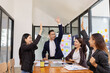 © SOMKID - Group of Asian businesspeople Join hands and work together as a team in modern office, Business startup and company strategy planning concept.