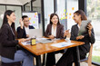 © SOMKID - Group of Asian business working plan analysis project brainstorm in modern office, Asian businesspeople team working together, Business startup and company strategy planning concept.