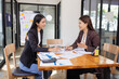 © SOMKID - Businesswomen working plan analysis project brainstorm in modern office, Asian businesspeople team working together, Business startup and company strategy planning concept.