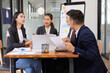 © SOMKID - Group of Asian business working with analysis project brainstorm in modern office, Asian businesspeople team working together, Business startup and company strategy planning concept.