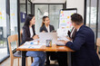 © SOMKID - Group of Asian business working with analysis project brainstorm in modern office, Asian businesspeople team working together, Business startup and company strategy planning concept.