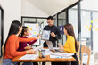 © SOMKID - Group of Asian business working analysis project brainstorm in modern office, Asian businesspeople team working together, Business startup and company strategy planning concept.