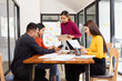 © SOMKID - Group of Asian business working analysis project brainstorm in modern office, Asian businesspeople team working together, Business startup and company strategy planning concept.