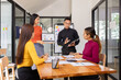 © SOMKID - Group of Asian business people holding laptop computer working together and presentation a meeting in office, Business person group and new idea project creative concept.