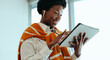 © Jacob Lund - Smiling woman using digital tablet in office