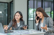 © panomporn - Two businesswoman hands or accountants working together on financial investment on calculator, calculating, analyzing business growth and marketing on graph.