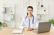 © Studio Romantic - Portrait of a serious female doctor or nurse sitting at the desk in a hospital, clinic office. The medical staff member demonstrates professionalism and dedication to medicine and patient care.
