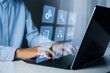 © Armin - Business person working on a laptop with digital icons representing business processes and management modern technology and workflow automation concept