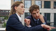 © stockbusters - Professional coworkers discussing strategy project at outdoors terrace closeup.