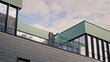 © stockbusters - Business colleagues talking balcony office building. Partners discussing work