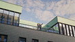 © stockbusters - Business partners standing balcony modern office building. Businessman pointing