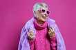 © oneinchpunch - Funny grandmother with fashionable clothes. Concept about old people in the influencer business.