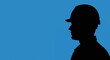 © NN AI - Construction worker silhouette against blue sky. Professional builder in hard hat profile view. Labor and industry concept