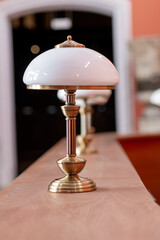 Poster - Elegant Brass Table Lamp on Wooden Surface Display