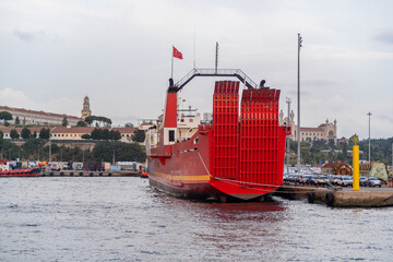 Poster - Bosphorus harbor features a large red cargo ship docked against a historical backdrop during the early evening hours