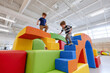 © Luluraschi - colorful soft-play climbing structure with textured foam blocks, curious toddlers exploring safely