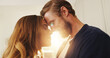 © peopleimages.com - Home, forehead and couple with love, lens flare or bonding together with happiness, romance or trust. Apartment, support or man with woman, relationship or marriage with kindness, commitment or smile