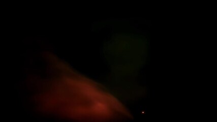 Wall Mural - abstract image of blurry red and green lights against a black background. a small light is visible i