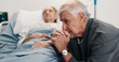 © peopleimages.com - Elderly couple, sick and sad man with stress by hospital bed, cancer diagnosis and healthcare. Terminal illness, woman and clinic visitor with patient for hope, thinking and prayer for recovery