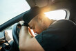© Chanakon - Young asian muslim islamic driver was drowsy. Yawned and was about to fall asleep in car doze off. Driving for a long time sleep deprivation. Campaign for safe driving