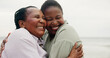 © peopleimages.com - Mature mother, daughter and hug on beach for travel, holiday and getaway trip. Women, African family and space with embrace for love, retirement vacation and bonding together for affection in nature