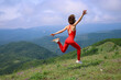 © yanlev - young woman enjoying freedom and nature on top of green mountain