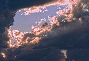 Wall Mural - sun and sky appearing in a hole in the clouds after a rain storm