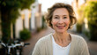 © Nataliya - A joyful mature woman walking with a bicycle on a quiet street