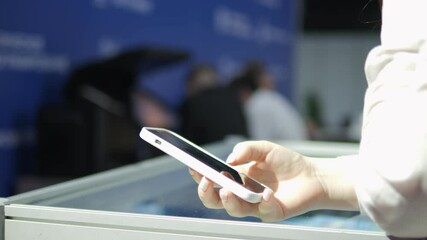 Person is holding a cell phone and texting. Concept of modern technology and communication