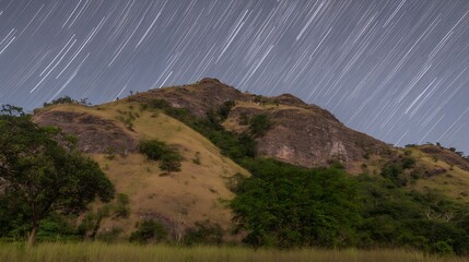 Wall Mural - Star trails over the rolling hill