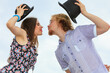 © Voyagerix - Couple flirting kissing on date against sky background