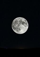 Wall Mural - majestic full moon night sky - a stunning full moon dominates a dark night sky, speckled with distan