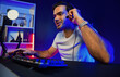© InfiniteFlow - Smart gaming streamer talking with team member players using headset and mic for communicate with others on streaming live on social media application at digital neon lighting studio room. Surmise.