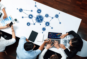Leinwandbilder - A diverse group of professionals collaborates in a modern office, analyzing data through digital illustrations, enhancing teamwork and strategic communication efforts. Amity