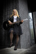 © Светлана Высокос - a woman with a guitar in a leather jacket and tutu skirt. A woman plays the guitar