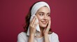 © Imagine Stuff - Woman wiping face with towel after bath; skin care routine. Spa background