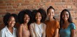 © Pete - Group of happy African American women smiling. Girls stand against red brick wall background. Diverse female friends, sisterhood, beauty, joy. Positive emotions, lifestyle concept.