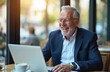 © Pete - Senior businessman celebrates success cafe. Happy elderly man in suit looks at laptop computer smiling laughing. Mature manager, entrepreneur achieves business victory, enjoying win. Cafe terrace,
