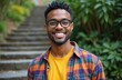© Pete - Attractive black man with beautiful smile outdoors. Happy guy wears glasses. Young adult with beard, earring. Casual lifestyle portrait, perfect teeth. Diversity concept.
