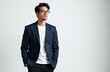 © Pete - Handsome businessman in stylish suit poses with confidence. Young professional man in formal wear, trendy glasses on white studio background. Perfect for business project design, fashion
