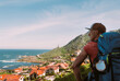 © Soloviova Liudmyla - As Marinas village landscape on Spanish Atlantic coast with male pilgrim carrying backpack on Camino Portuguese Way. Inspiring walk on famous Camino de Santiago. Travel, pilgrimage, lifestyle concept