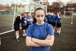© Davor - Confident girl soccer player posing in front of team on field