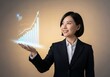 © Designer - Woman presenting an upward trending graph on her open palm hand