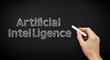 © MdNazim - Artificial intelligence concept written on a chalkboard with a hand holding chalk