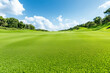 © smth.design - Lush green golf course landscape on a sunny day with clear blue skies and verdant rolling hills