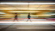 © Elena - Motion blur of a person walking in a dynamic urban environment with light trails